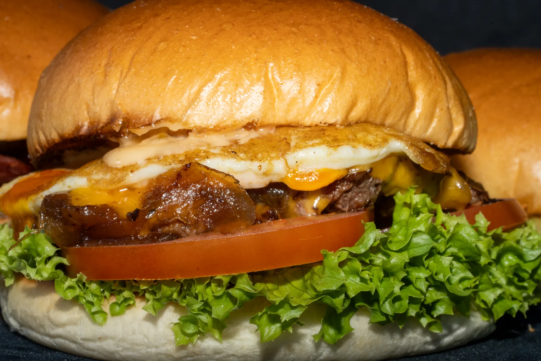 Close-up burger image showing lettuce, cheese and bun texture