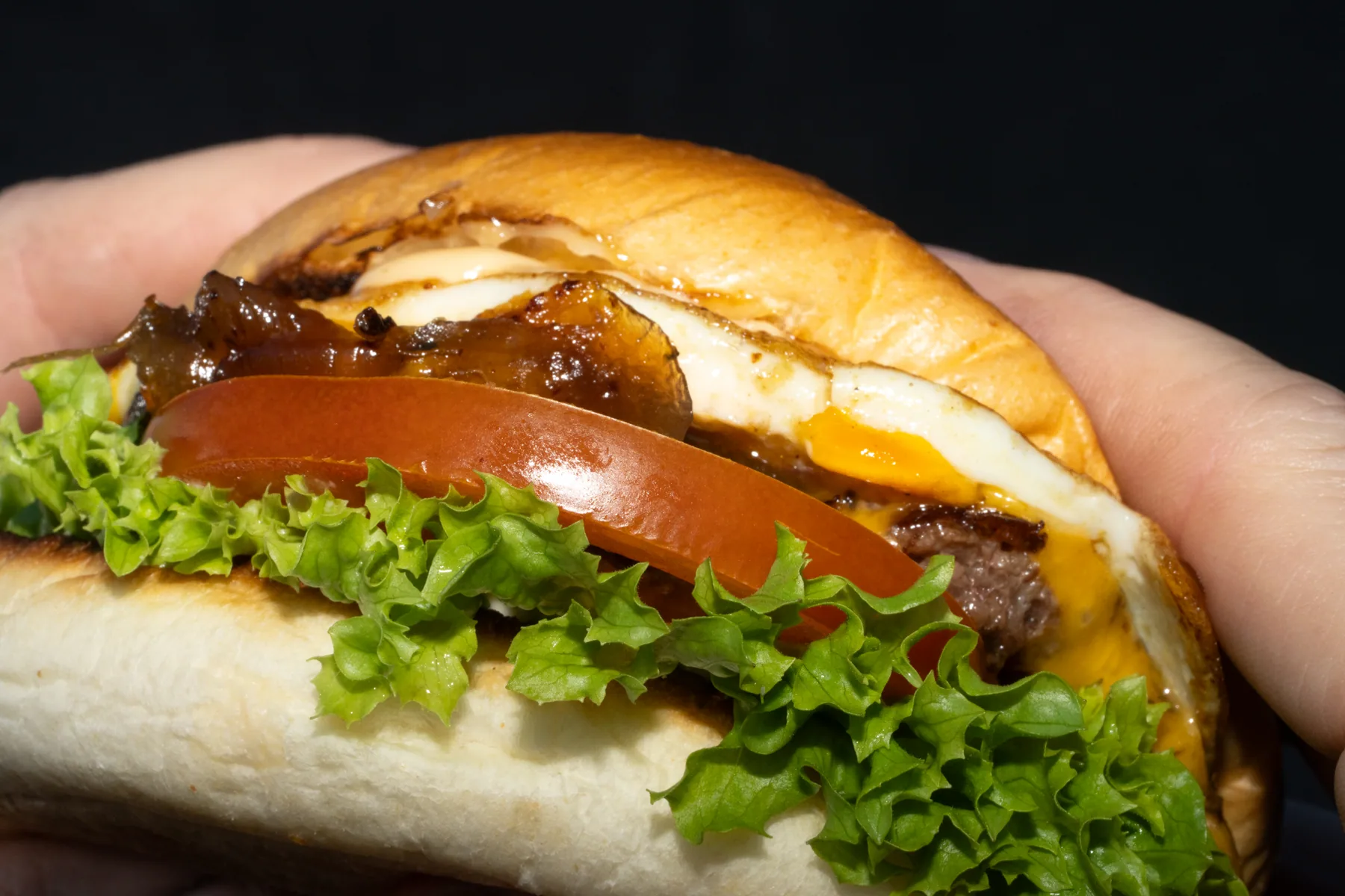 Hand holding a burger for social-ready food content