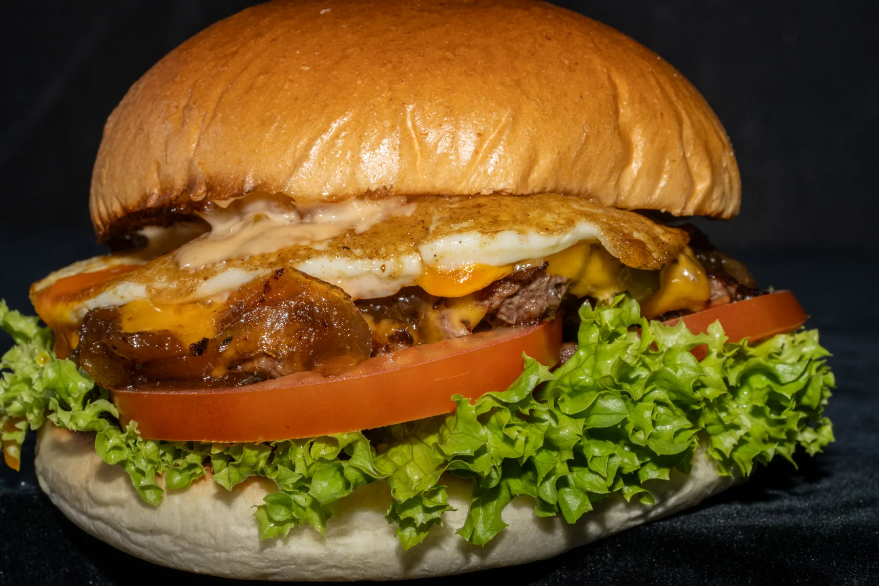 Close food photography of a burger on a dark backdrop
