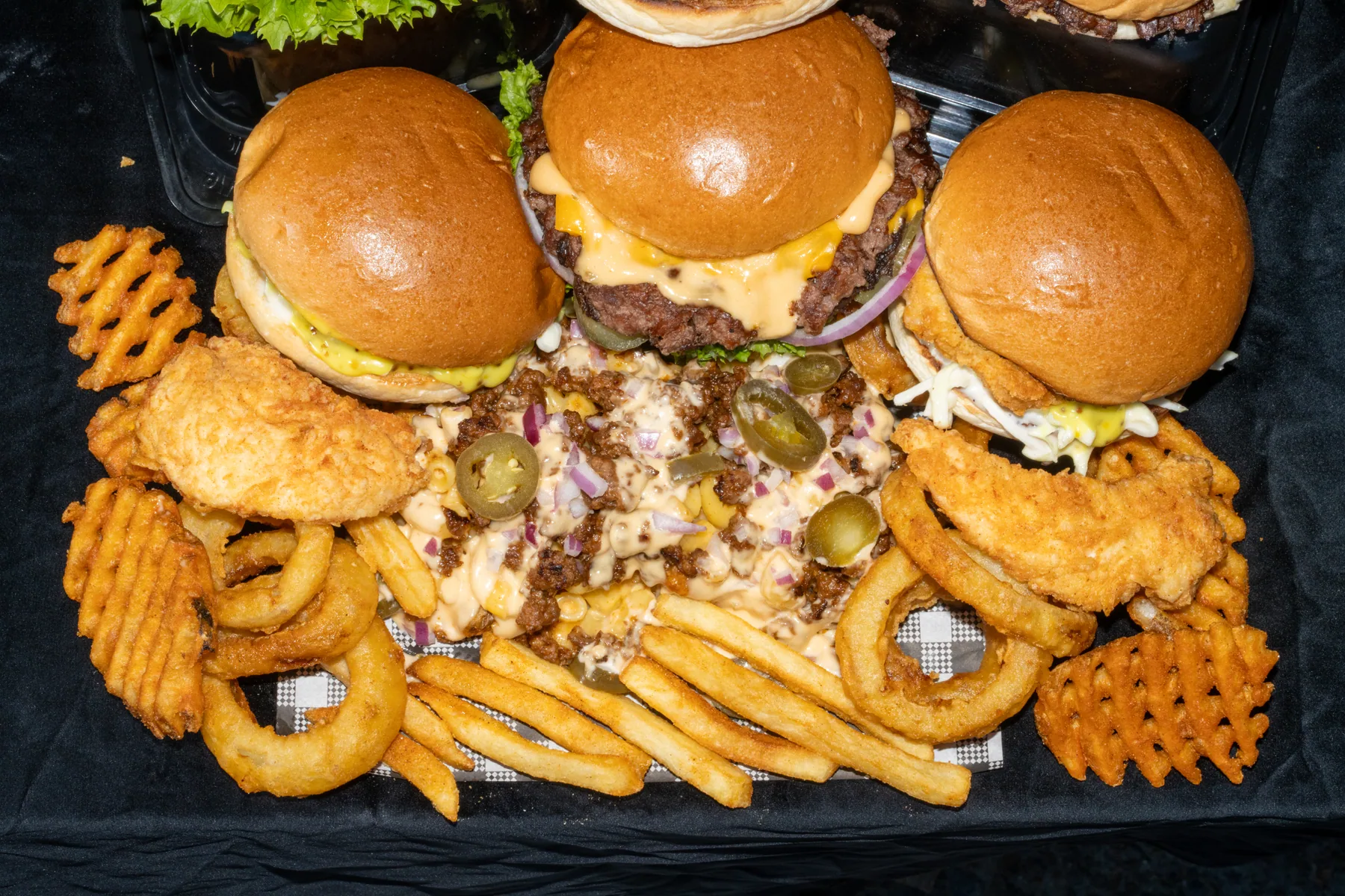 Overhead burger and sides spread photographed for a campaign asset