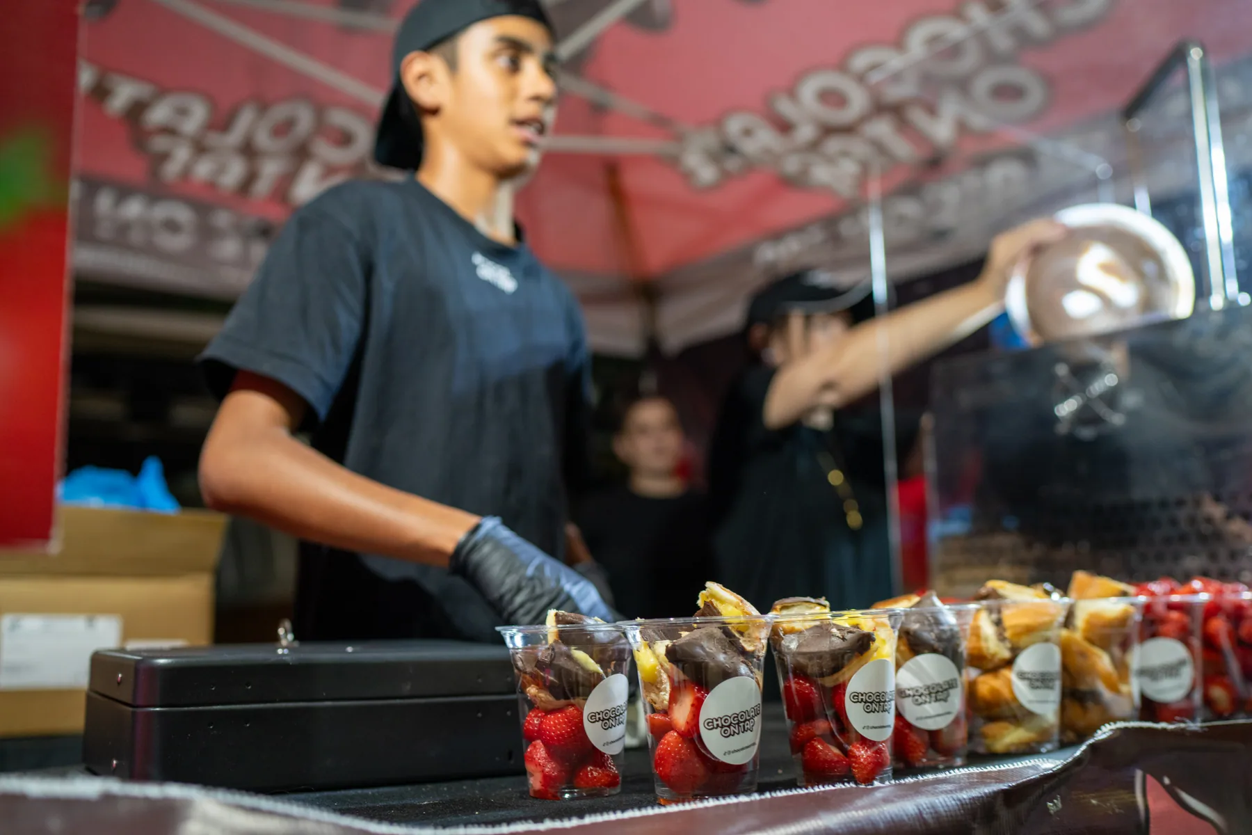 Vendor preparing food at a market stall