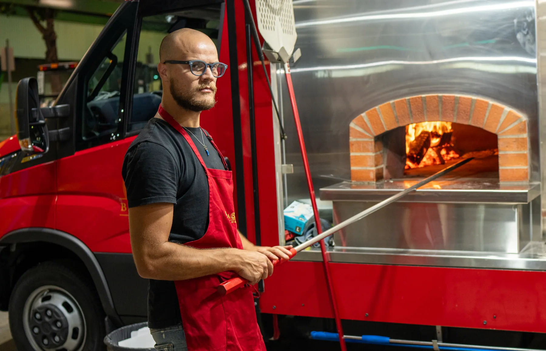 Food truck operator working at a woodfired oven
