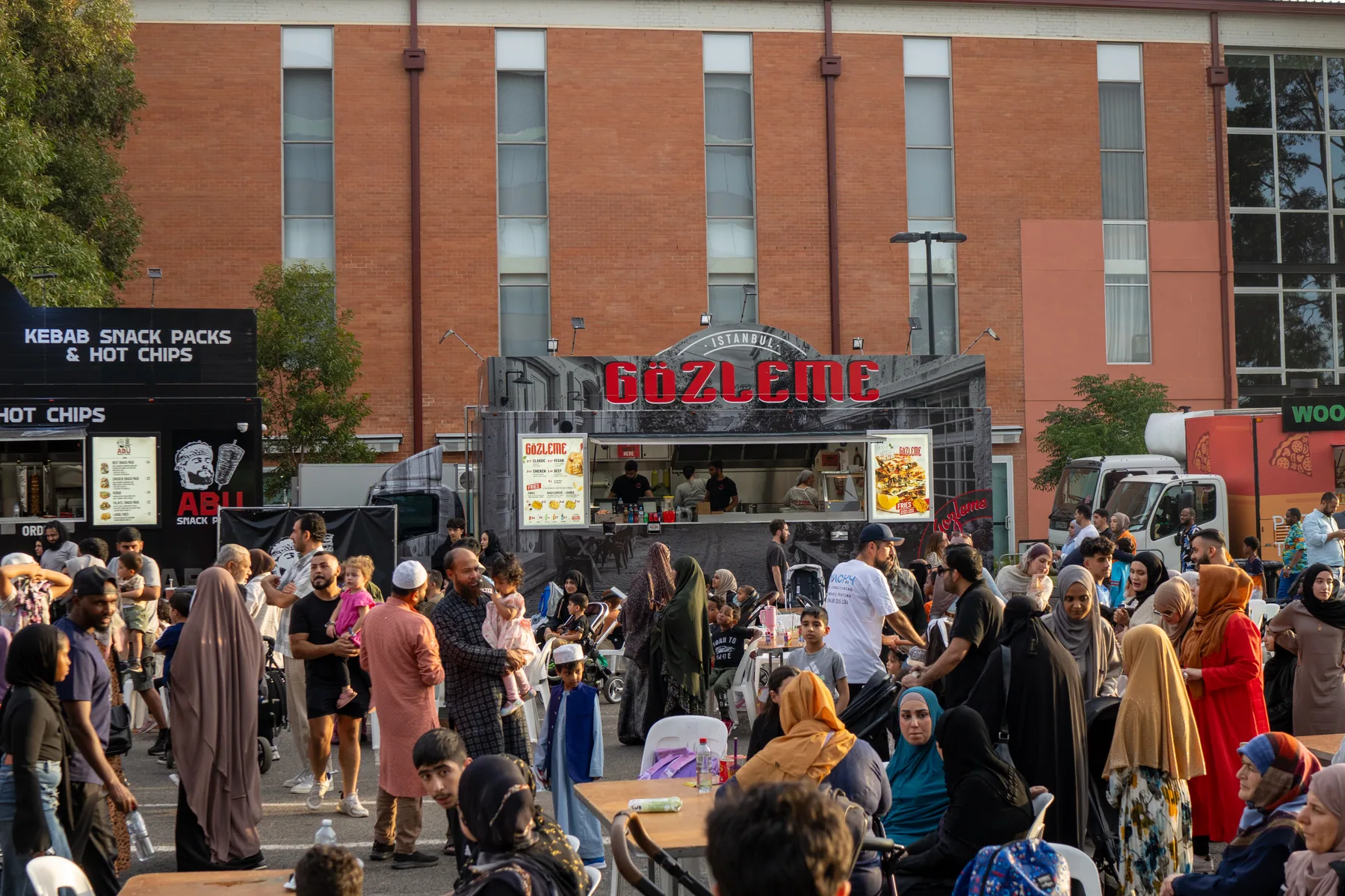 Crowd gathered near food vendors at a market event