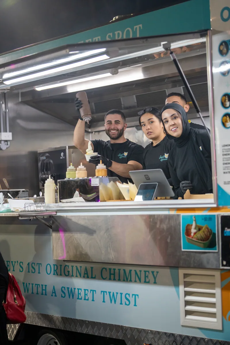 Market vendor team photographed inside a food stall