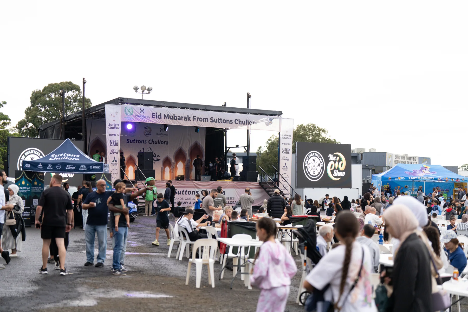 Stage and seated crowd photographed during a community food event