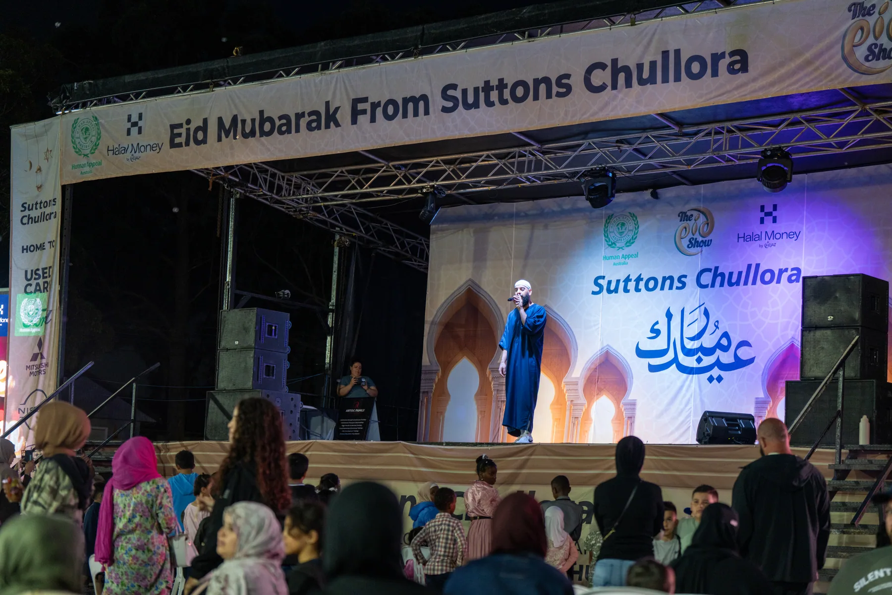 Stage performance photographed during community event coverage