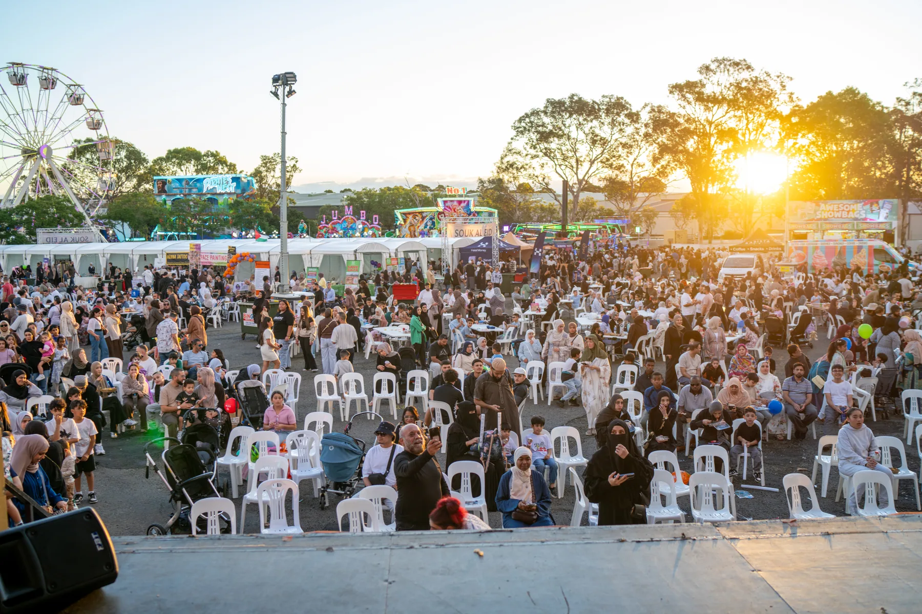 Stage crowd photographed near sunset during event coverage